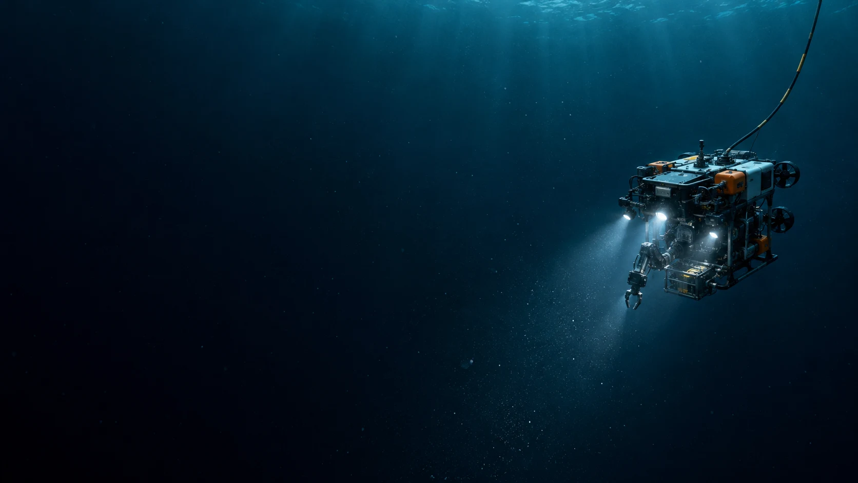 A research submersible sends beams of light into a vast, dark blue ocean